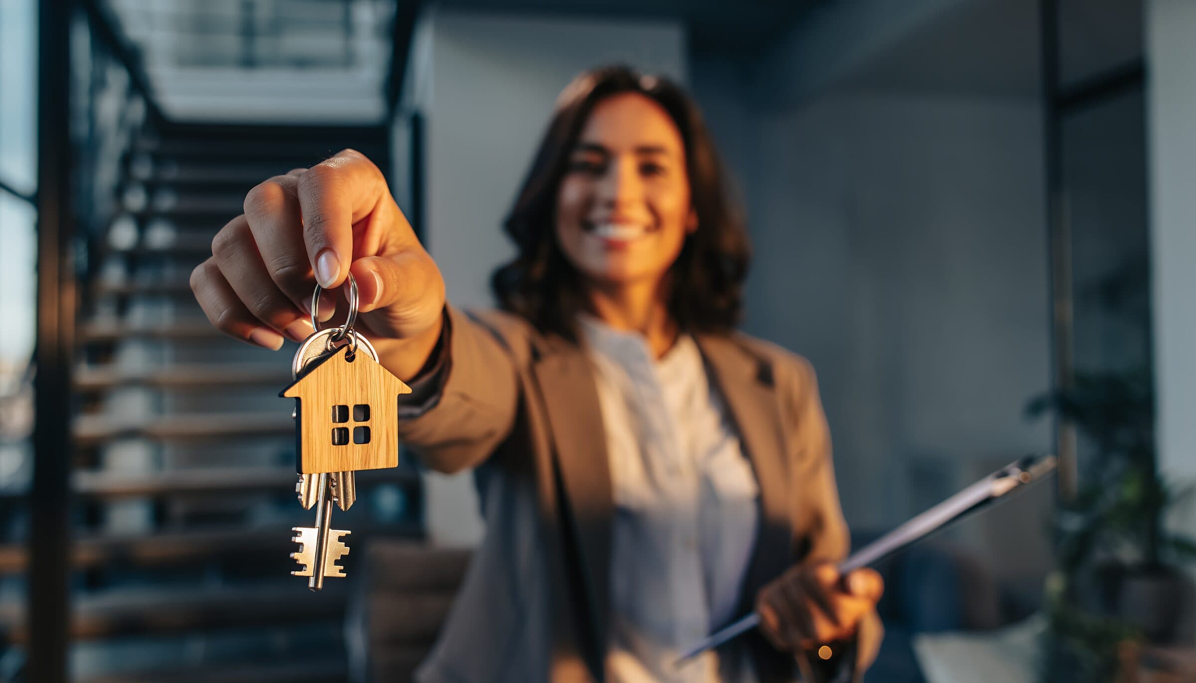 A First Choice Mortgage loan officer handing over the keys to a family's new home